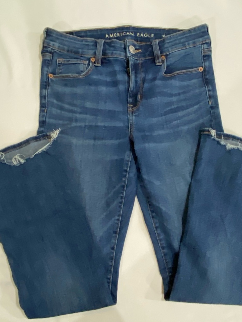 American Eagle jeans Women's sz 8 Skinny Kick super stretch Back hem distressed